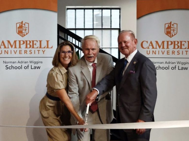Benji Jones, Dean Rich Leonard, and Terry Hutchens cutting a ribbon at an event for Campbell University Norman Adrian Wiggins School of Law. Photo courtesy of “Campbell University Norman Adrian Wiggins School of Law.”