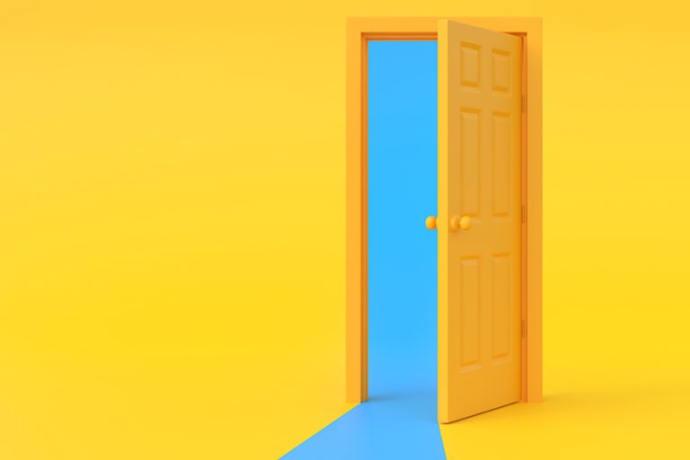 Bright yellow door partially open against a yellow wall revealing a blue interior space beyond the doorway.