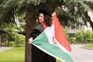 law school graduate holding flag of Mexico