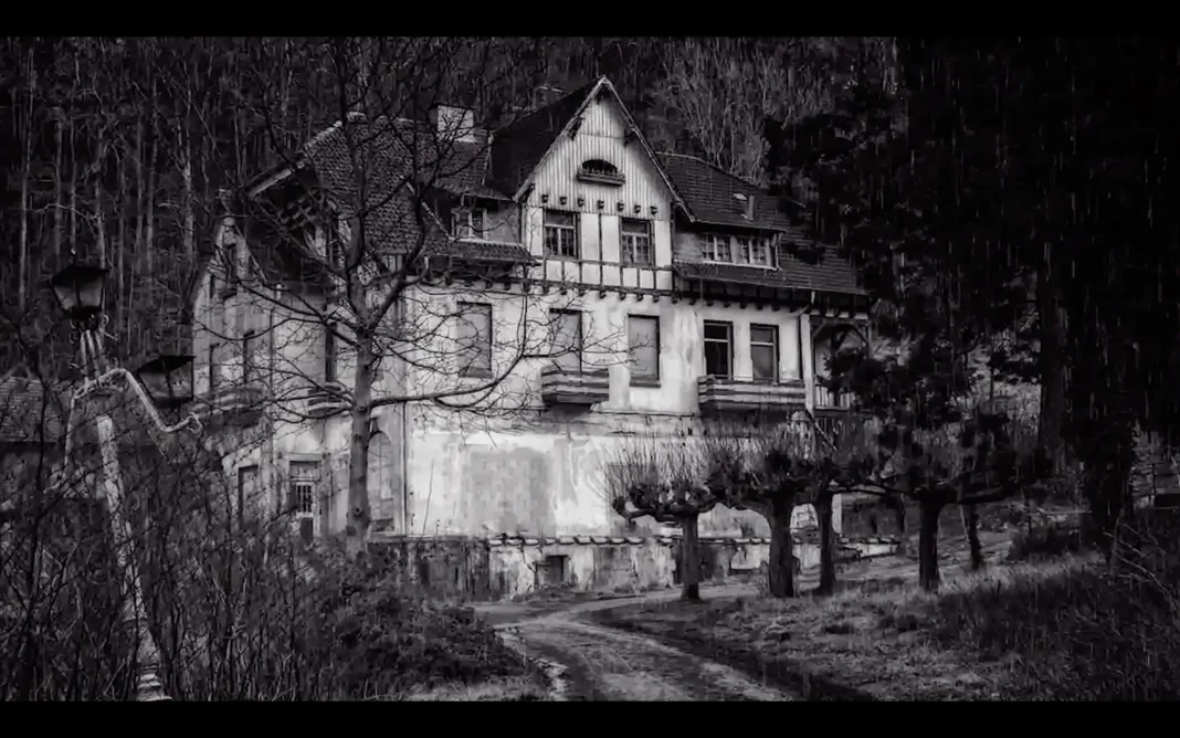 An old, abandoned house with boarded-up windows sits in a wooded area during rainfall, creating a dark and eerie atmosphere that suggests a haunted or neglected property.