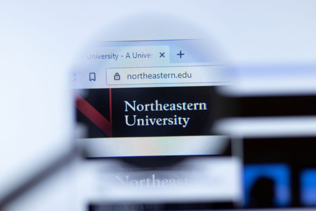 Northeastern Law website on screen through a magnifying glass