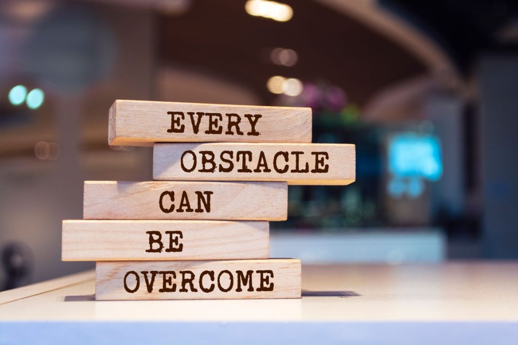 blocks stacked with the words Every Obstacle Can Be Overcome
