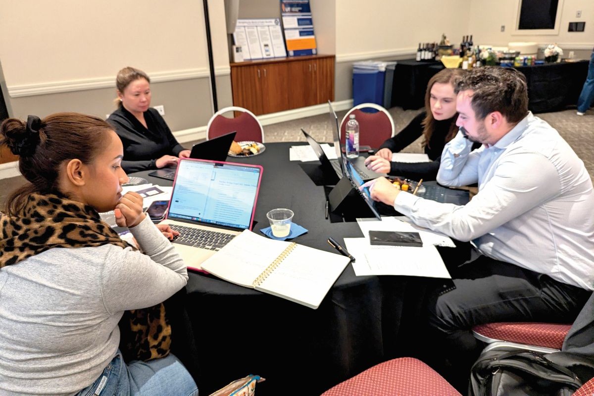 Suffolk law students working at a round table