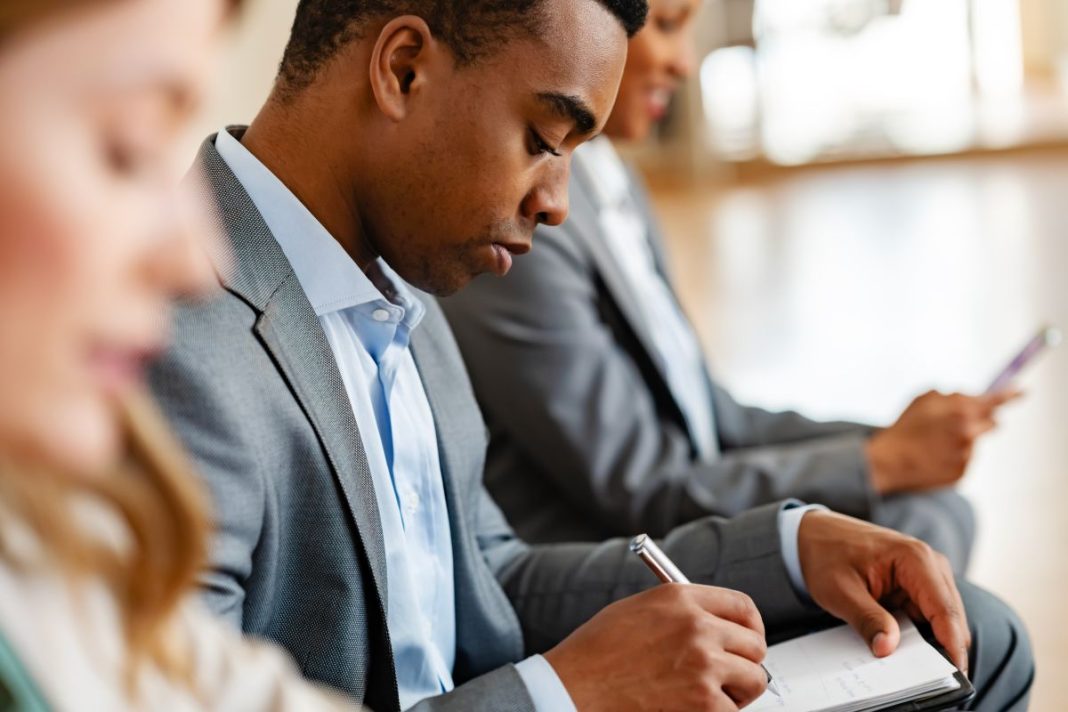 male candidate getting ready for job interview looking at notes