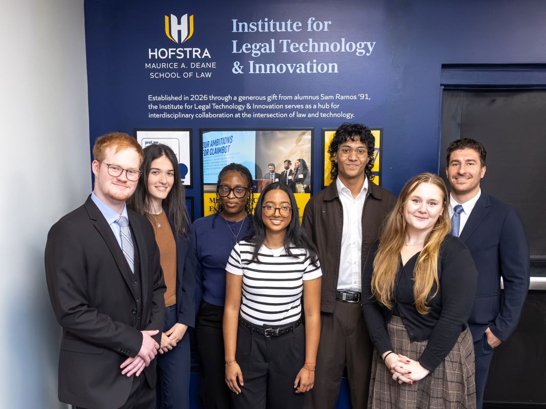 Hofstra Law Deans' Legal-Tech Fellows standing in front of new institute sign