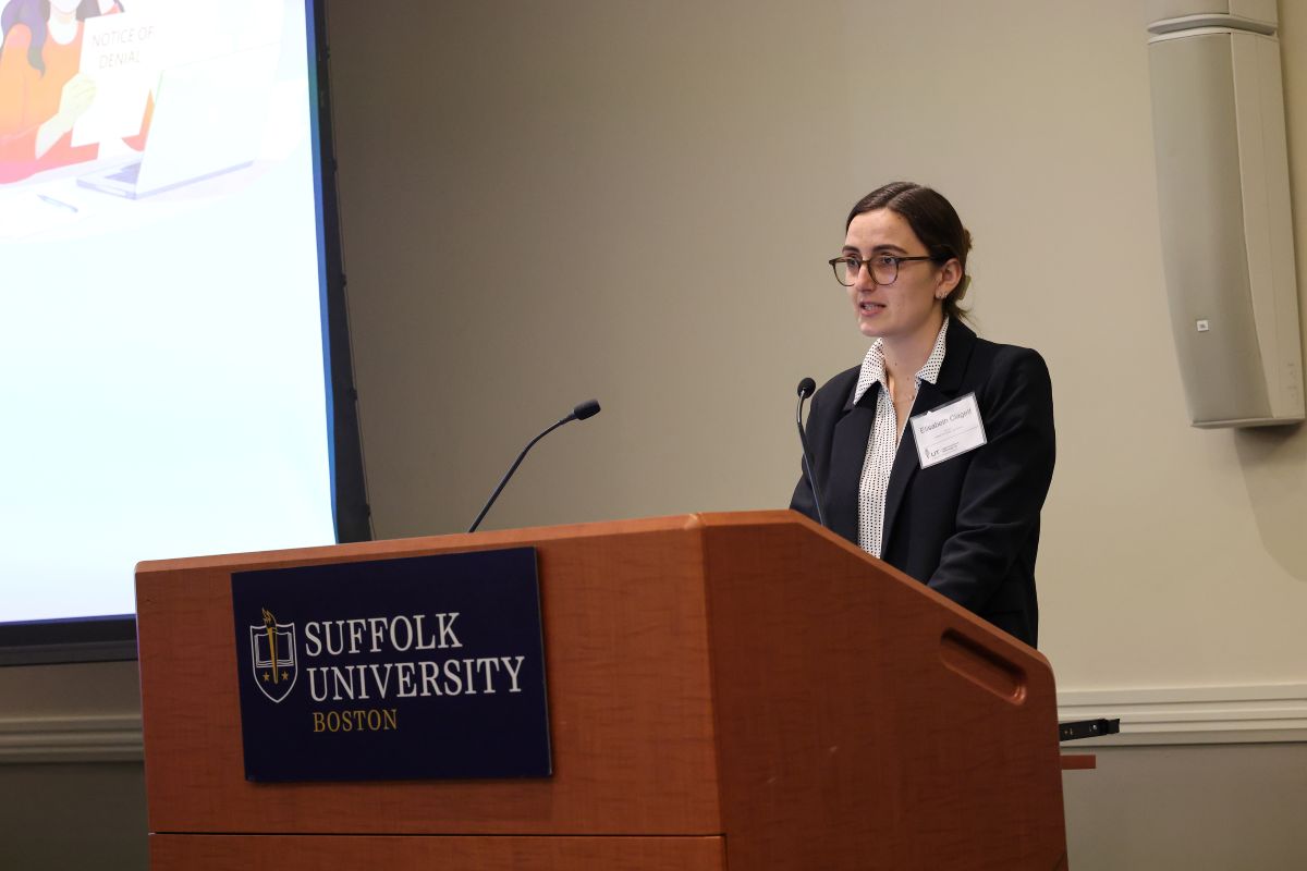 Suffolk Law student at podium presenting